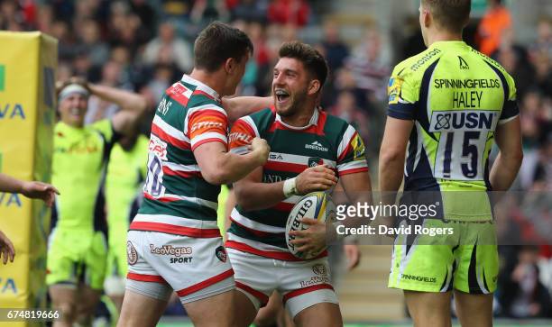 Owen Williams of Leicester celebrates with team mate Freddie Burns after scoring their third try during the Aviva Premiership match between Leicester...