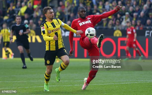 Marcel Schmelzer of Dortmund challenges Anthony Modeste of Koeln during the Bundesliga match between Borussia Dortmund and 1. FC Koeln at Signal...