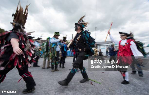 Morris dancers with their faces painted black as part of a traditional disguise perform at the Green Man Spring Festival on April 29, 2017 in Bovey...