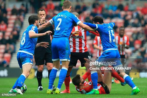 Sunderland's Italian striker Fabio Borini is confrunted by Bournemouth players after a challenge on Bournemouth's English midfielder Lewis Cook...