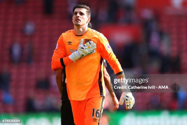 Eldin Jakupovic of Hull City pats the badge on his chest after the Premier League match between Southampton and Hull City at St Mary's Stadium on...