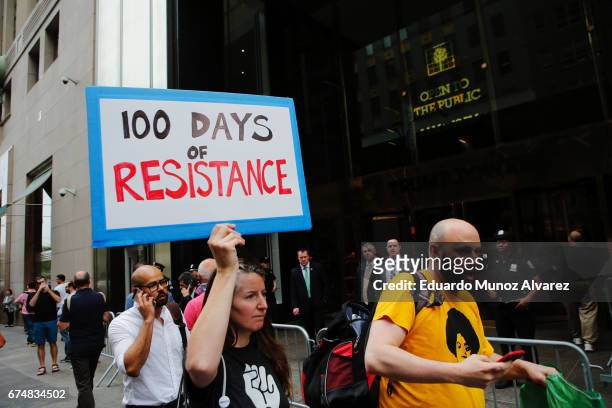 Woman walks in front of Trump Tower as activists take part in a protest against US President Donald Trump at Trump Tower on April 29, 2017 in New...