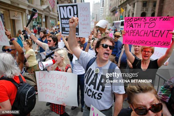 Protesters take part in the '100 Days of Failure' Protest as they mark the first 100 days of the administration of US President Donald Trump on April...