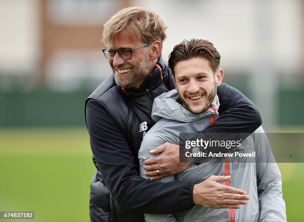 Jurgen Klopp manager of Liverpool with Adam Lallana during a training session at Melwood Training Ground on April 29, 2017 in Liverpool, England.