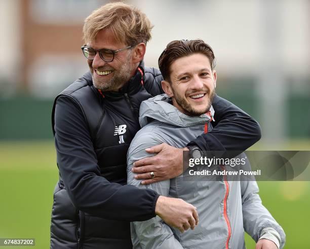 Jurgen Klopp manager of Liverpool with Adam Lallana during a training session at Melwood Training Ground on April 29, 2017 in Liverpool, England.