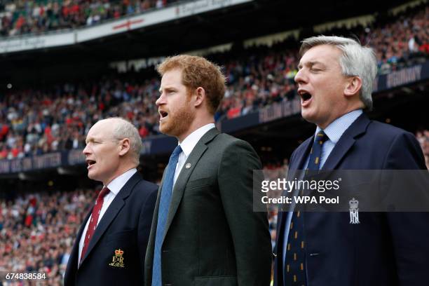 Prince Harry sings the national anthem ahead of the annual Army Navy armed forces rugby match at Twickenham stadium on April 29, 2017 in London,...