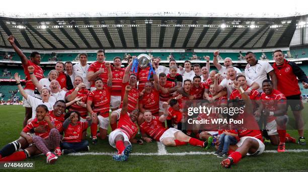 The Army team celebrate their victory with the Babcock Trophy at the end of the annual Army Navy armed forces rugby match at Twickenham stadium on...