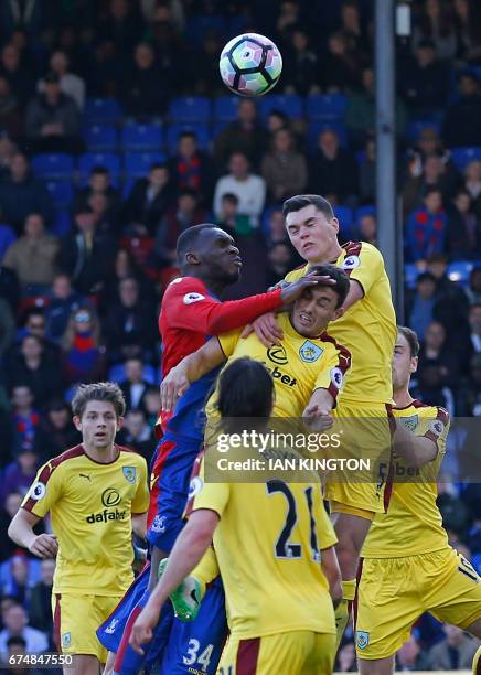 Crystal Palace's Zaire-born Belgian striker Christian Benteke and Burnley's English defender Michael Keane jump to contest a header during the...