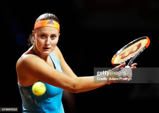 Kristina Mladenovic of France plays a backhand in her match against Maria Sharapova of Russia during the Porsche Tennis Grand Prix at Porsche Arena...