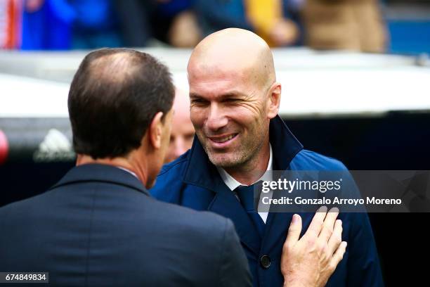 Head coach Zinedine Zidane of Real Madrid CF clashes hands with head coach Salvador alias Voro Gonzalez of Valencia CF during the La Liga match...