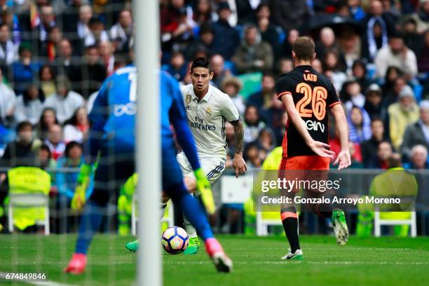 James Rodriguez of Real Madrid CF competes for the ball with Antonio Latorre alias Lato and his teammate goalkeeper Diego Alves during the La Liga...