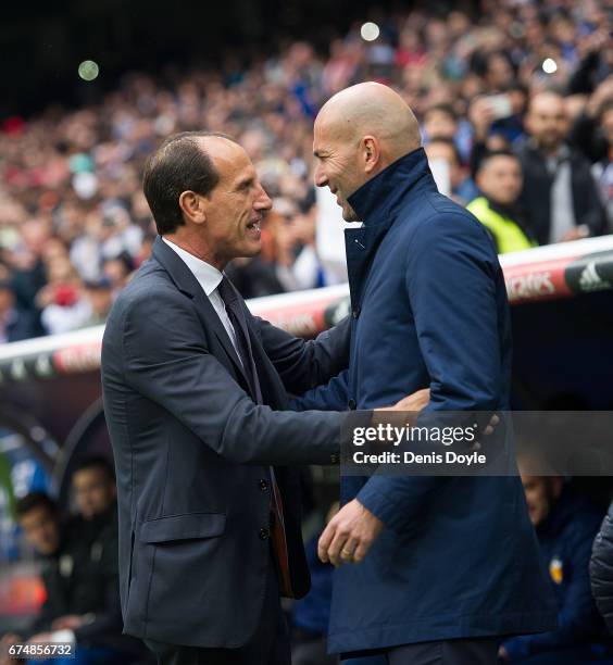 Real Madrid manager Zinedine Zidane greets manager Salvador Gonzalez Marco VoroÕ of Valencia CF before the start of the La Liga match between Real...