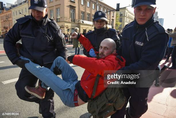 Police take some protesters into custody during a protest against the nationalist Far Right March part of the 83rd anniversary of the ONR in Warsaw,...