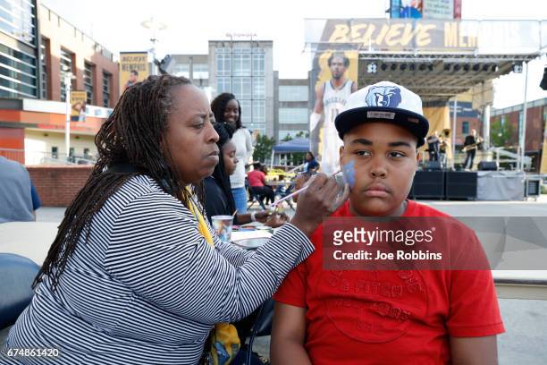 Fan gets their face painted before the game between the Memphis Grizzlies and the San Antonio Spurs during Game Six of the Western Conference...
