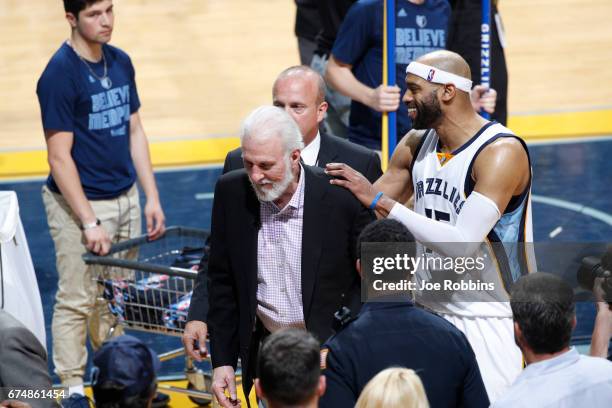 Vince Carter of the Memphis Grizzlies pats Gregg Popovich of the San Antonio Spurs on the back during the game during Game Six of the Western...