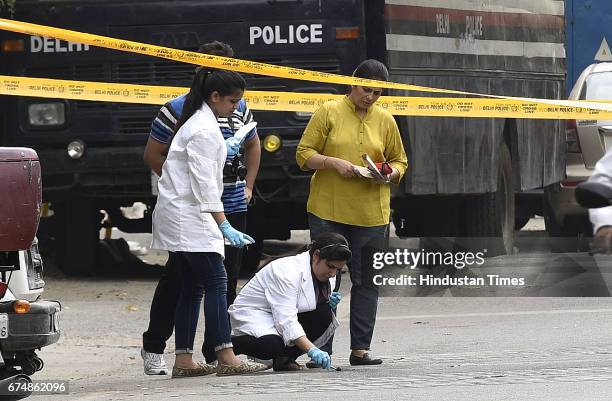 Delhi Police officer and forensic experts collect the samples outside Rohini court on April 29, 2017 in New Delhi, India. Rajesh, a notorious...