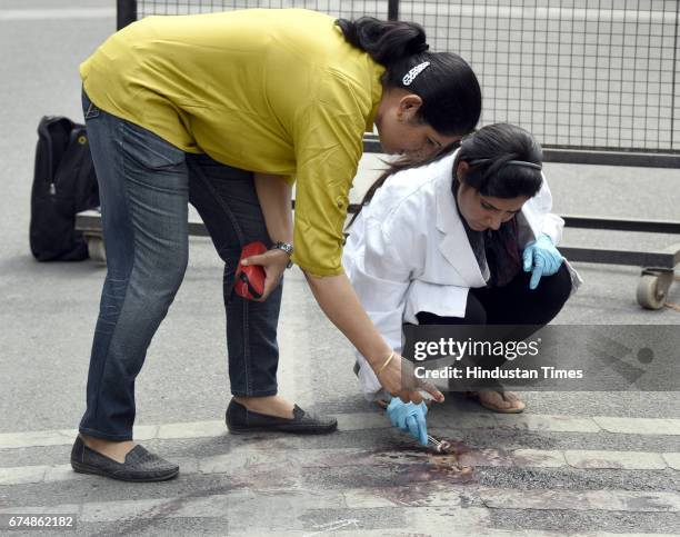 Delhi Police officer and forensic experts collect the samples outside Rohini court on April 29, 2017 in New Delhi, India. Rajesh, a notorious...