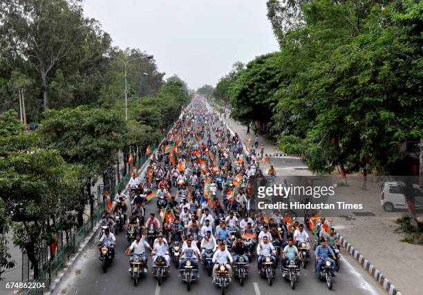 Workers holding a motorcycle rally to accord a 'grand welcome' to BJP national President Amit Shah, who is on a two-day visit to Jammu on April 29,...