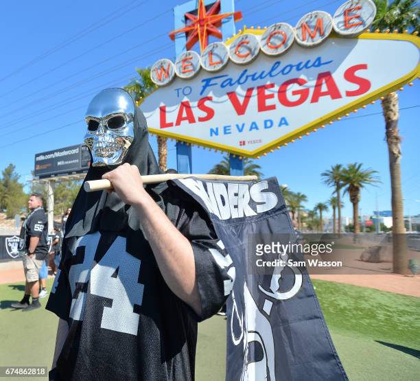 An Oakland Raiders fan attends the team's 2017 NFL Draft event at the Welcome to Fabulous Las Vegas sign on April 29, 2017 in Las Vegas, Nevada....