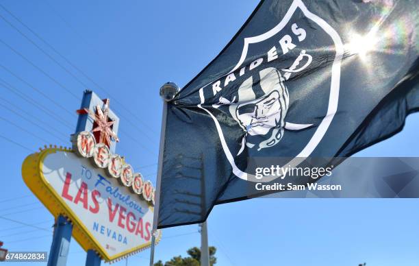 An Oakland Raiders flag is shown during the team's 2017 NFL Draft event at the Welcome to Fabulous Las Vegas sign on April 29, 2017 in Las Vegas,...