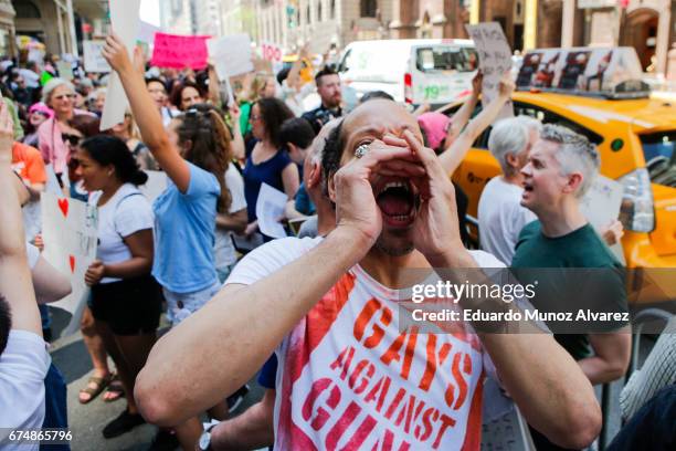 People march against US president Donald Trump as they take part in the '100 Days of Failure' protest on April 29, 2017 in New York City. Activists...