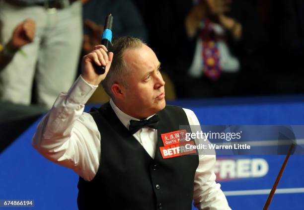 John Higgins of Scotland celebrates winning his semi-final match against Barry Hawkins of England on day fifteen of Betfred World Championship 2017...