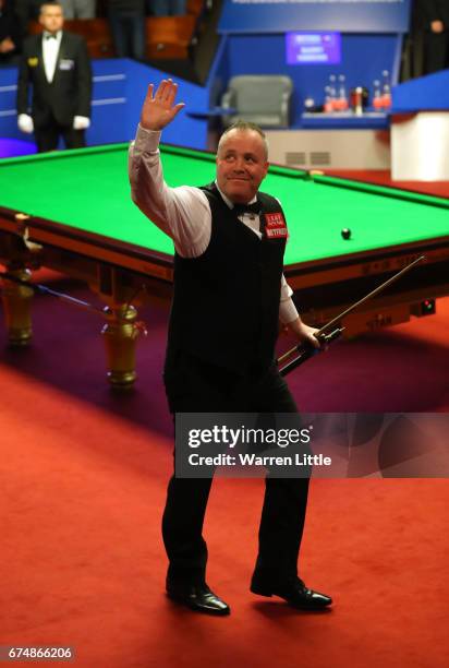 John Higgins of Scotland celebrates winning his semi-final match against Barry Hawkins of England on day fifteen of Betfred World Championship 2017...