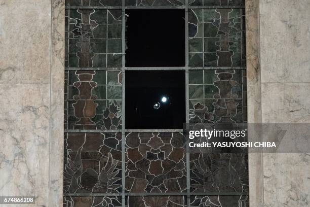 Men use flashlights to see inside the Municipal Theatre in Rio de Janeiro, Brazil, as they extinguish a fire caused in the early morning by an...