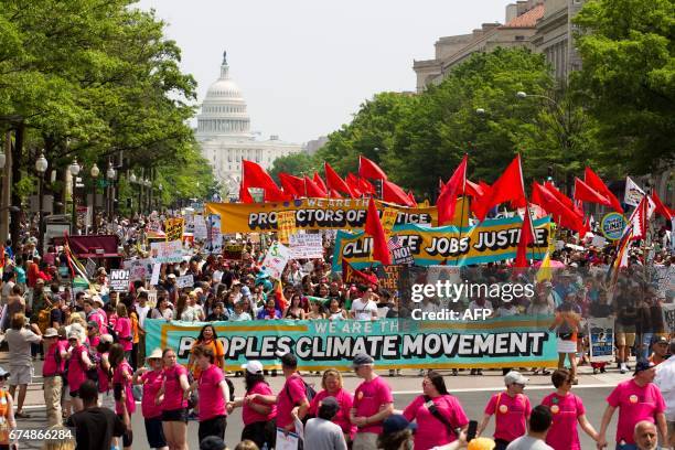 Demonstrators march on Pennsylvania Avenue during the People's Climate March in Washington DC, on April 2017.