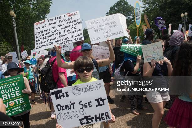 Protesters hold signs and chant in front of the White House during the People's Climate March in Washington, DC, on April 29, 2017.