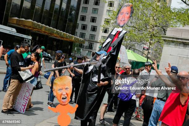 People march against US president Donald Trump as they take part in the '100 Days of Failure' protest on April 29, 2017 in New York City. Activists...