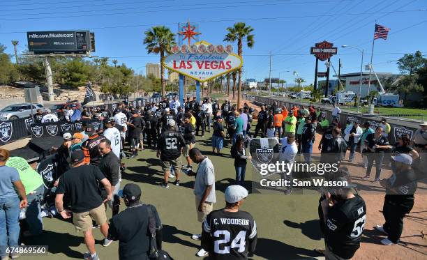 Oakland Raiders fans gather for the team's 2017 NFL Draft event at the Welcome to Fabulous Las Vegas sign on April 29, 2017 in Las Vegas, Nevada....