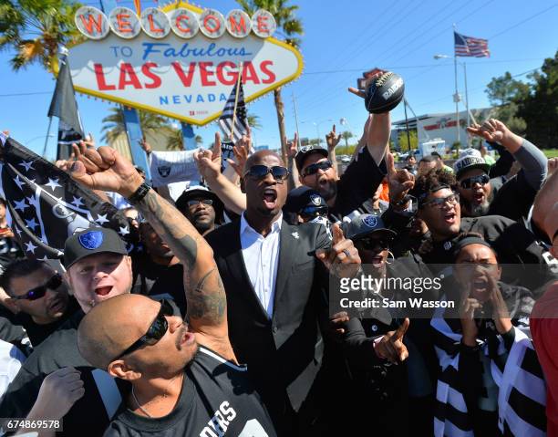 Former Oakland Raiders player Akbar Gbajabiamila leads Oakland Raiders fans in a cheer during the team's 2017 NFL Draft event at the Welcome to...