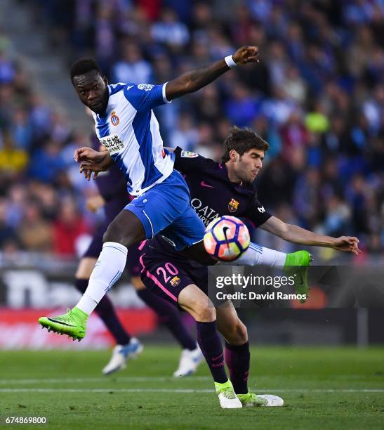 Felipe Caicedo of RCD Espanyol competes for the ball with Sergi Roberto of FC Barcelona during the La Liga match between RCD Espanyol and FC...