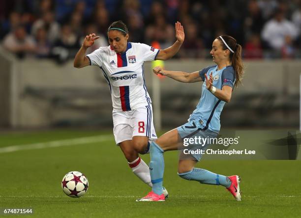 Jessica Houara-DHommeaux of Olympique Lyon jumps a tackle from Kosovare Asllani of Manchester City during the UEFA Women's Champions League Semi...