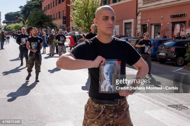 Anti-fascists hold photos as they take part in a parade in remembrance of the struggle for liberation from Nazi-fascism on April 29, 2017 in Rome,...