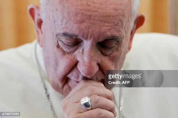 Pope Francis speaks to the press from aboard his plane on April 29 on his return flight from Cairo to Rome.