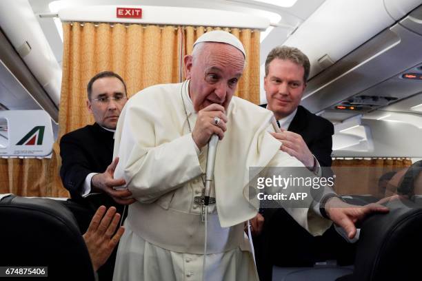 Pope Francis speaks to the press from aboard his plane on April 29 on his return flight from Cairo to Rome. / AFP PHOTO / POOL / GREGORIO BORGIA