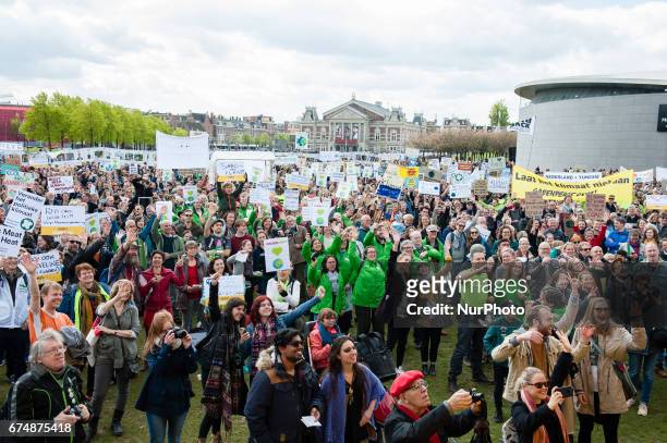 Thousands of people take part in the &quot;People's Climate March&quot; to call for an ambitious climate policy, on April 29, 2017 in Amsterdam. The...