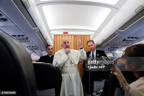 Pope Francis speaks to the press from aboard his plane on April 29 on his return flight from Cairo to Rome. / AFP PHOTO / POOL / GREGORIO BORGIA