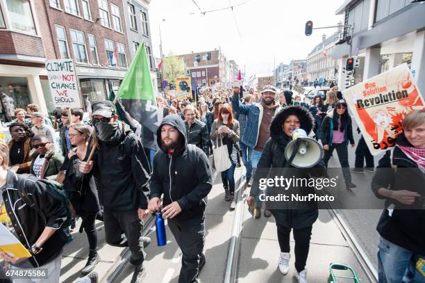 Thousands of people take part in the &quot;People's Climate March&quot; to call for an ambitious climate policy, on April 29, 2017 in Amsterdam. The...