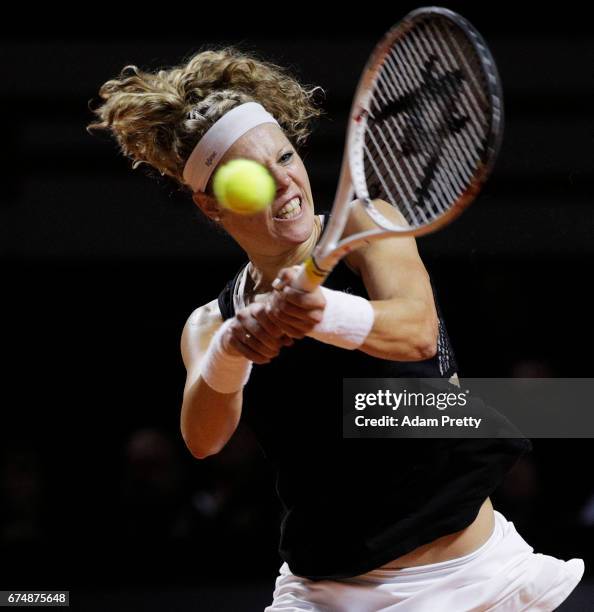 Laura Siegemund of Germany plays a backhand during her match against Simona Halep of Romania during the Porsche Tennis Grand Prix at Porsche Arena on...