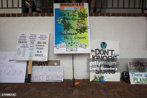 Signs sit next to a wall during a breakfast reception ahead of the People's Climate Movement March in Washington, D.C., U.S., on Saturday, April 29,...