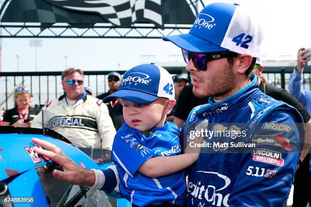 Kyle Larson, driver of the Credit One Bank Chevrolet, celebrates with his son, Owen, in Victory Lane after winning the NASCAR XFINITY Series...