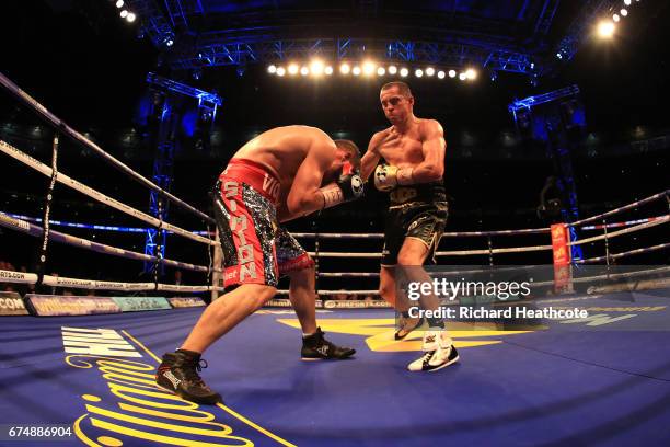 Scott Quigg and Viorel Simion in action during the IBF Featherweight bout at Wembley Stadium on April 29, 2017 in London, England.