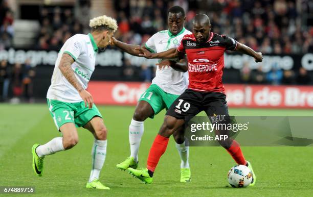 Guingamp's French forward Yannis Salibur vies with Saint-Etienne's French defender Kevin Malcuit and Saint-Etienne's French midfielder Yohan Mollo...