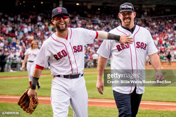 Former Boston Red Sox third baseman Kevin Youkilis reacts with Dustin Pedroia of the Boston Red Sox after throwing out the ceremonial first pitch...
