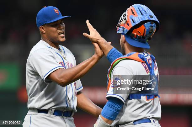 Jeurys Familia of the New York Mets celebrates with Rene Rivera after a 5-3 victory against the Washington Nationals at Nationals Park on April 29,...