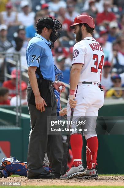 Bryce Harper of the Washington Nationals argues a called strike with home plate umpire John Tumpane in the seventh inning against the New York Mets...