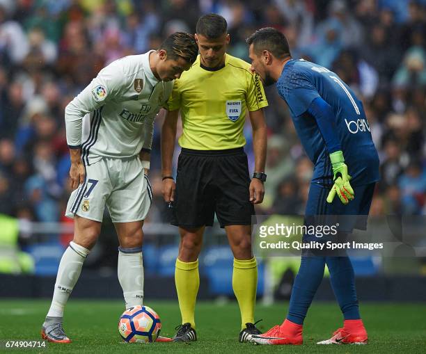 Cristiano Ronaldo of Real Madrid argues with Diego Alves of Valencia prior a penalty during the La Liga match between Real Madrid CF and Valencia CF...